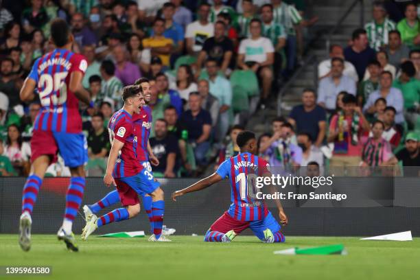 Ansu Fati of FC Barcelona celebrates with teammates after scoring their team's first goal during the La Liga Santander match between Real Betis and...
