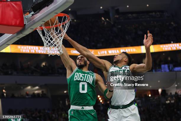 Jayson Tatum of the Boston Celtics is fouled by Giannis Antetokounmpo of the Milwaukee Bucks during the second quarter of Game Three of the Eastern...