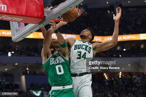 Jayson Tatum of the Boston Celtics is fouled by Giannis Antetokounmpo of the Milwaukee Bucks during the second quarter of Game Three of the Eastern...
