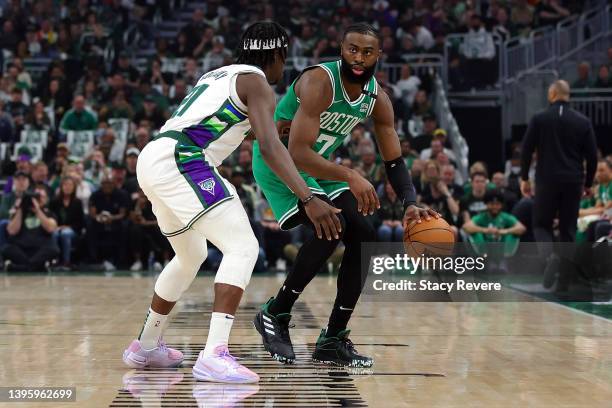 Jaylen Brown of the Boston Celtics is defended by Jrue Holiday of the Milwaukee Bucks during the first quarter of Game Three of the Eastern...