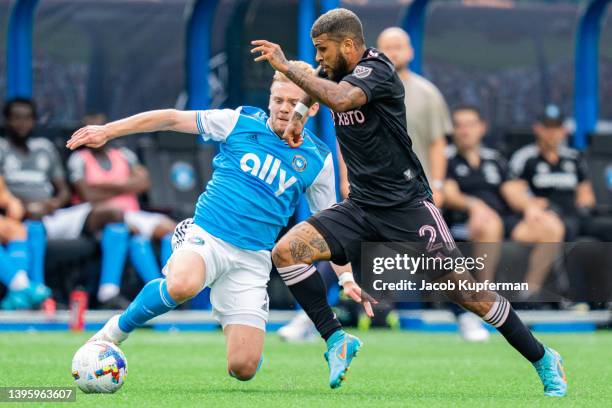 Kamil Jozwiak of Charlotte FC tries to knock the ball away from DeAndre Yedlin of Inter Miami in the first half during their game at Bank of America...
