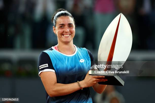 Ons Jabeur of Tunisia celebrates with the trophy following victory during the Women's Singles final match against Jessica Pegula of the United States...