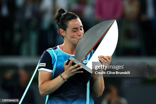 Ons Jabeur of Tunisia celebrates with the trophy following victory during the Women's Singles final match against Jessica Pegula of the United States...