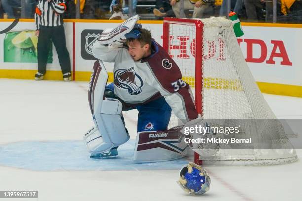 Darcy Kuemper of the Colorado Avalanche yanks off his mask after being hit by a stick in the first period during Game Three of the First Round of the...