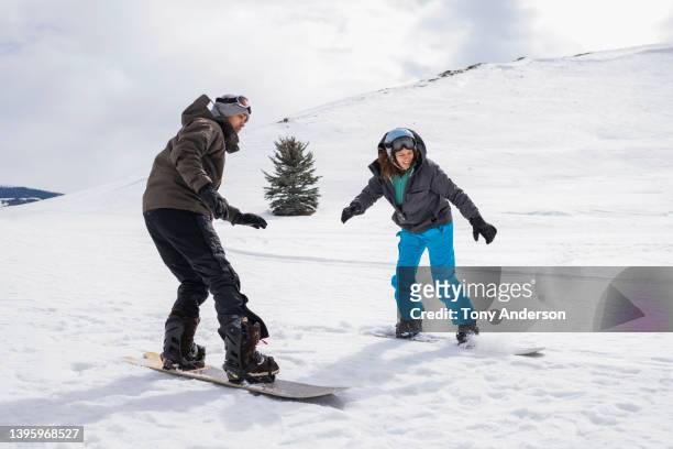 young couple snowboarding - snowboard bildbanksfoton och bilder