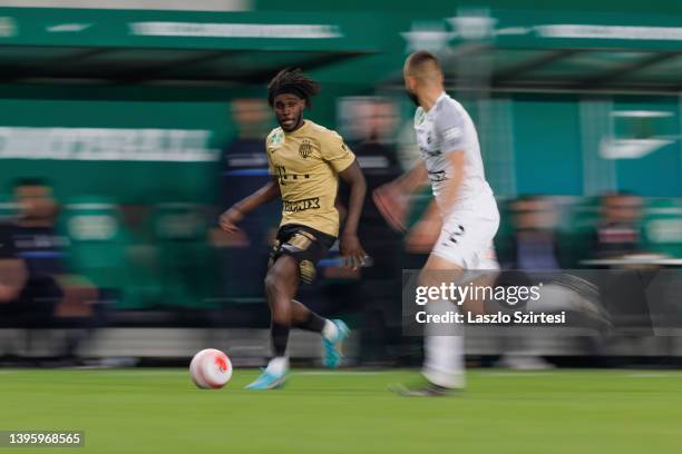 Tokmac Chol Nguen of Ferencvarosi TC runs with the ball next to Benedek Varju of MTK Budapest during the Hungarian OTP Bank Liga match between...