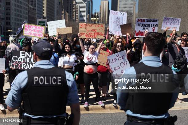 Police separate abortion-rights demonstrators from a small group of anti-abortion demonstrators following a pro-choice march through downtown on May...
