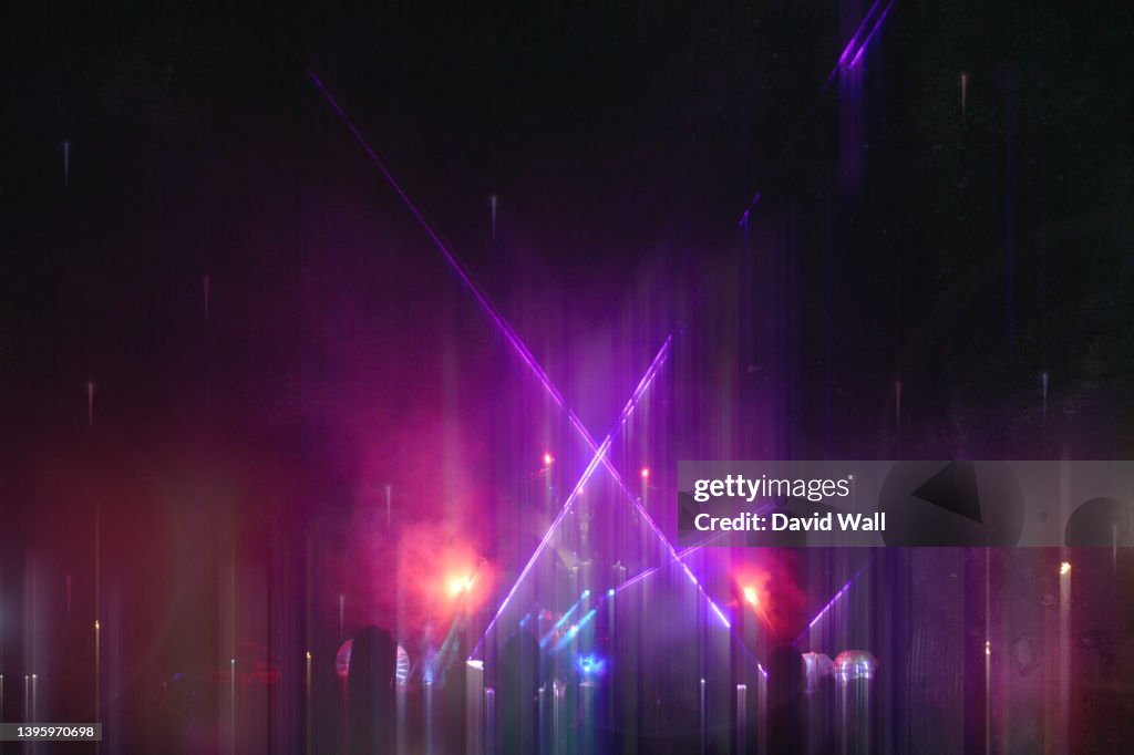 A neon abstract concept. Of a party at a music festival. With lasers and lights. With a blurred dream like edit