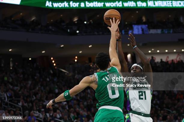 Jayson Tatum of the Boston Celtics blocks a shot by Jrue Holiday of the Milwaukee Bucks during the second half of Game Three of the Eastern...