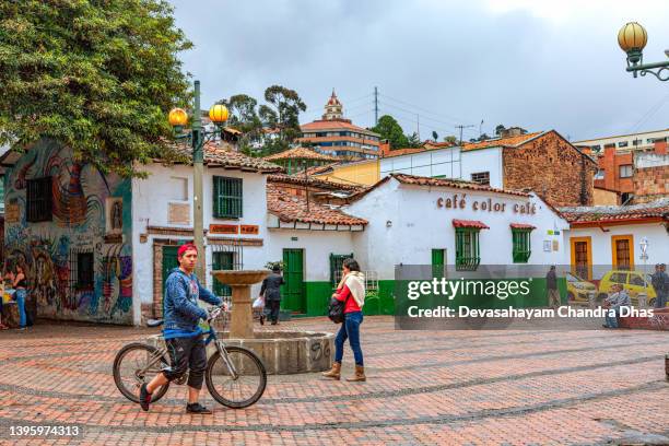 bogota, colombia - local colombian people and a few tourists enjoying the historic plaza chorro de quevedo in the candelaria district of the andes capital city - la candelaria bogota stock pictures, royalty-free photos & images