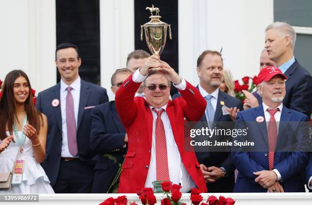 Trainer Eric Reed holds the trophy after Rich Strike won the 148th running of the Kentucky Derby at Churchill Downs on May 07, 2022 in Louisville,...