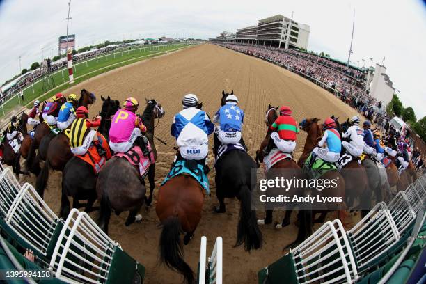 The field leaves the starting gate to begin the 148th running of the Kentucky Derby at Churchill Downs on May 07, 2022 in Louisville, Kentucky. Rich...