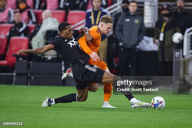 May 07: Donovan Pines of D.C. United and Tyler Pasher of Houston Dynamo batteries for the ball during the first half of the MLS game at Audi Field on...