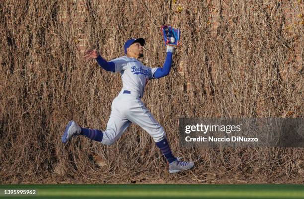 Mookie Betts of the Los Angeles Dodgers is unable to catch the triple by Willson Contreras of the Chicago Cubs during the first inning of Game Two of...