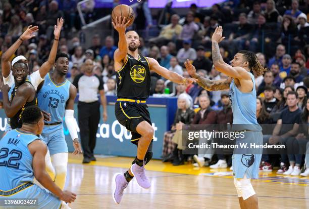 Stephen Curry of the Golden State Warriors drives to the basket for a layup and gets fouled by Brandon Clarke of the Memphis Grizzlies during the...