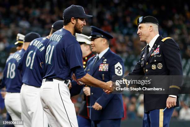 Danny Young of the Seattle Mariners greets military members during Salute to Armed Forces Night before the game against the Tampa Bay Rays at...
