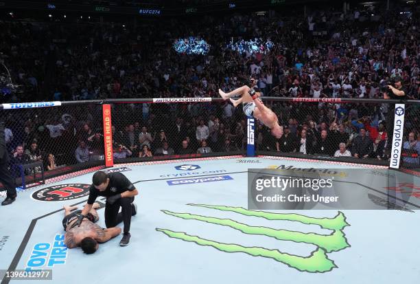 Michael Chandler celebrates after his knockout victory over Tony Ferguson in a lightweight fight during the UFC 274 event at Footprint Center on May...