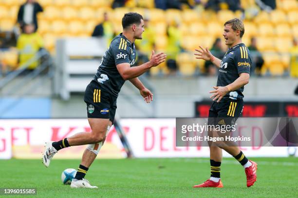 Joshua Moorby of the Hurricanes celebrates with Aidan Morgan after scoring a try during the round 12 Super Rugby Pacific match between the Hurricanes...