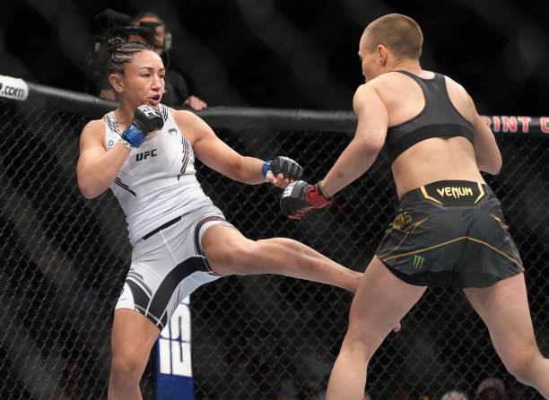 Carla Esparza kicks Rose Namajunas in the UFC strawweight championship fight during the UFC 274 event at Footprint Center on May 07, 2022 in Phoenix,...