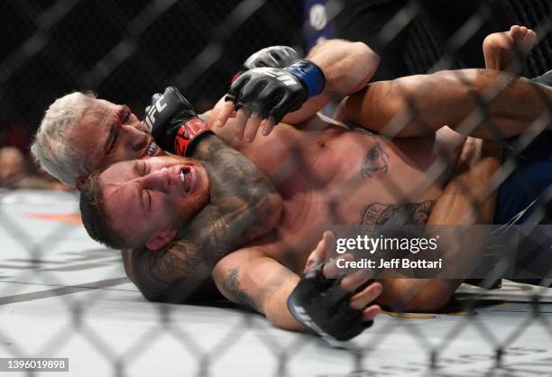 Charles Oliveira of Brazil secures a rear choke submission against Justin Gaethje in the UFC lightweight championship fight during the UFC 274 event...