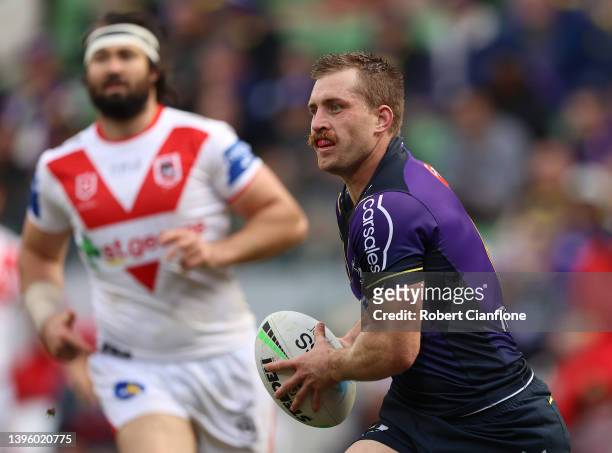 Cameron Munster of the Storm runs with the ball during the round nine NRL match between the Melbourne Storm and the St George Illawarra Dragons at...