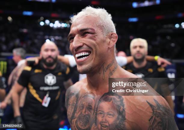 Charles Oliveira of Brazil reacts after his submission victory over Justin Gaethje in the UFC lightweight championship fight during the UFC 274 event...