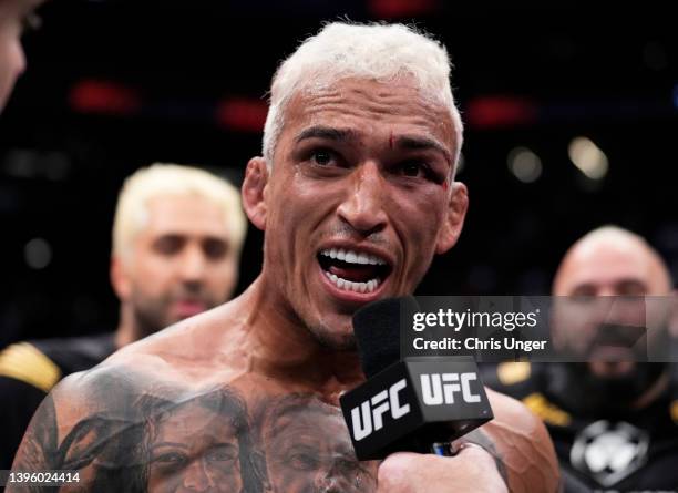 Charles Oliveira of Brazil reacts after his submission victory over Justin Gaethje in the UFC lightweight championship fight during the UFC 274 event...