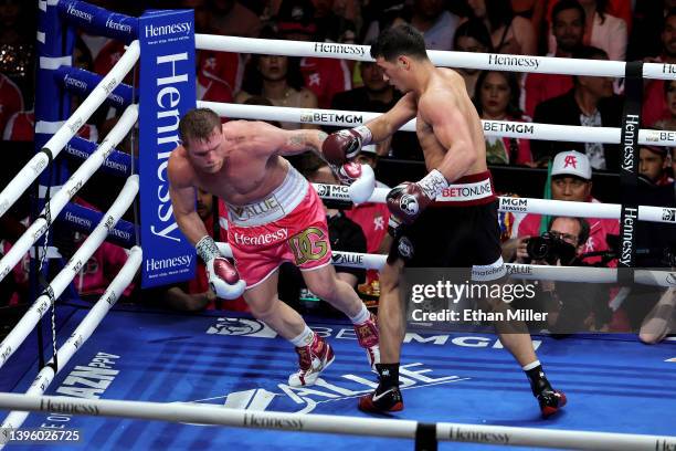 Dmitry Bivol punches Canelo Alvarez during their WBA light heavyweight title fight at T-Mobile Arena on May 07, 2022 in Las Vegas, Nevada. Bivol...