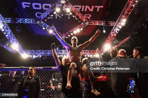 Charles Oliveira of Brazil celebrates after his submission victory over Justin Gaethje in their UFC lightweight championship bout during UFC 274 at...