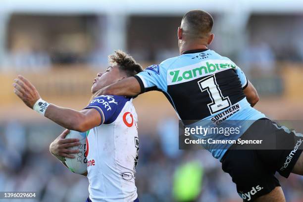 William Kennedy of the Sharks tackles Reece Walsh of the Warriors high during the round nine NRL match between the Cronulla Sharks and the New...