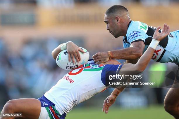 William Kennedy of the Sharks tackles Reece Walsh of the Warriors high during the round nine NRL match between the Cronulla Sharks and the New...