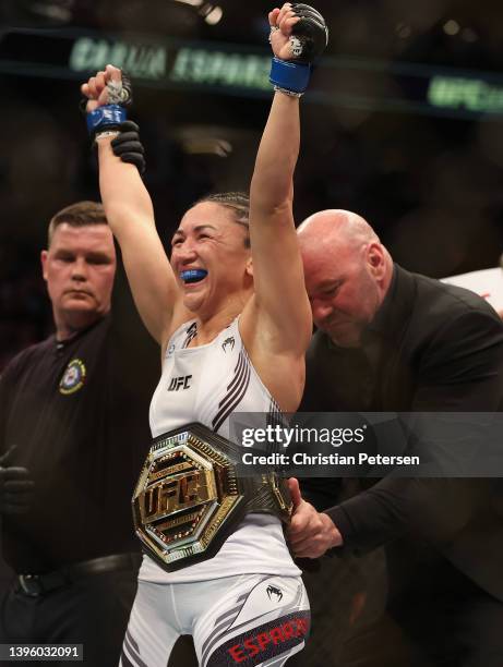 Carla Esparza celebrates after her victory over Rose Namajunas in their women’s strawweight championship bout during UFC 274 at Footprint Center on...