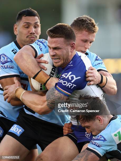Euan Aitken of the Warriors is tackled during the round nine NRL match between the Cronulla Sharks and the New Zealand Warriors at PointsBet Stadium,...