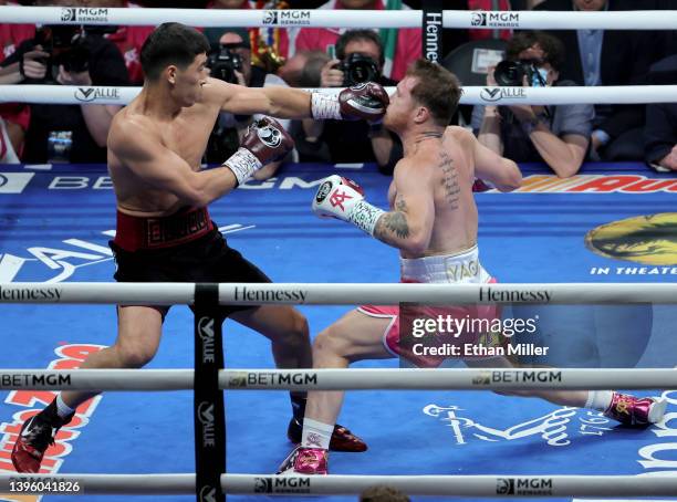 Dmitry Bivol hits Canelo Alvarez with a left in the first round of their WBA light heavyweight title fight at T-Mobile Arena on May 07, 2022 in Las...