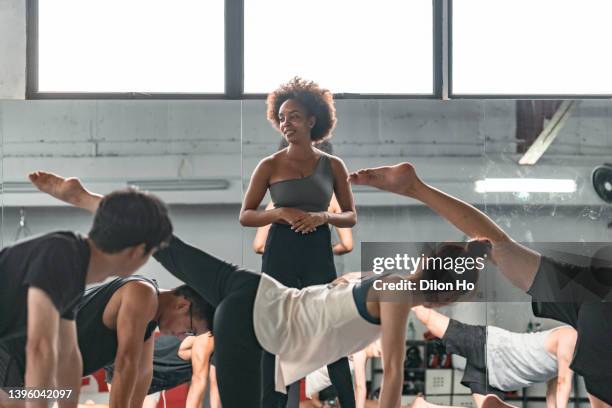 african american female instructor teaching yoga - yoga instructor stock pictures, royalty-free photos & images
