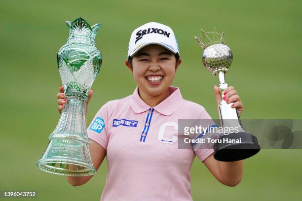 Miyuu Yamashita of Japan poses with the trophies after winning the tournament following the final round of World Ladies Championship Salonpas Cup at...