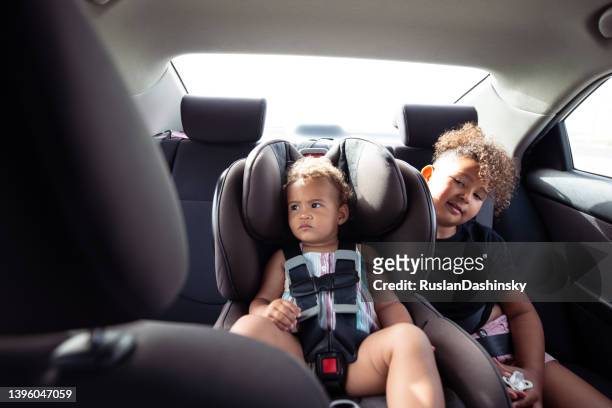 children traveling in rear car seats. - baby accessories the dummy stock pictures, royalty-free photos & images