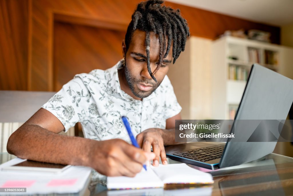 Noting Down Man Noting Down Important Points While Working From Home High-Res Stock ...