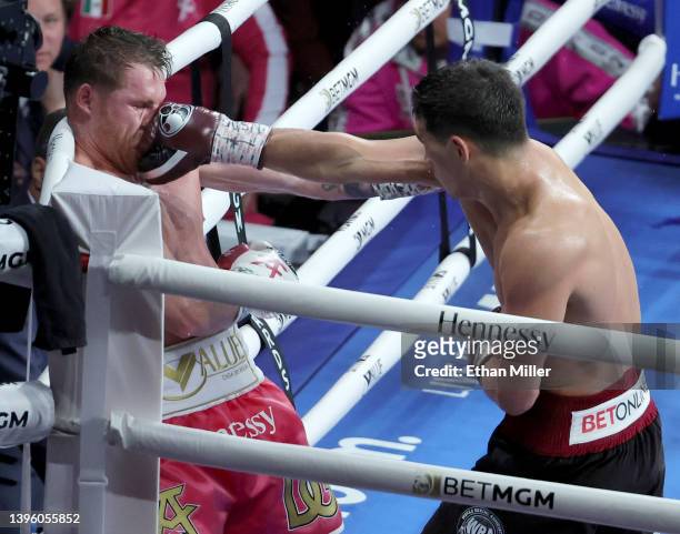 Dmitry Bivol hits Canelo Alvarez with a right in the eighth round of their WBA light heavyweight title fight at T-Mobile Arena on May 07, 2022 in Las...