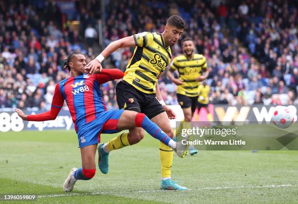 Michael Olise of Crystal Palace is tackled by Adam Masina of Watford during the Premier League match between Crystal Palace and Watford at Selhurst...