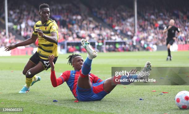 Wilfried Zaha of Crystal Palace is is fouled by Ismaila Sarr of Watford during the Premier League match between Crystal Palace and Watford at...