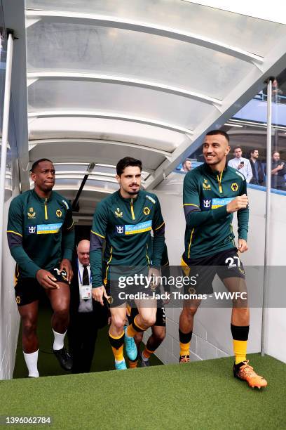 Willy Boly, Pedro Neto and Romain Saiss of Wolverhampton Wanderers walk out of the tunnel ahead of the Premier League match between Chelsea and...