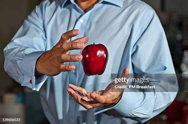 man playing magical trick - goocheltruc stockfoto's en -beelden