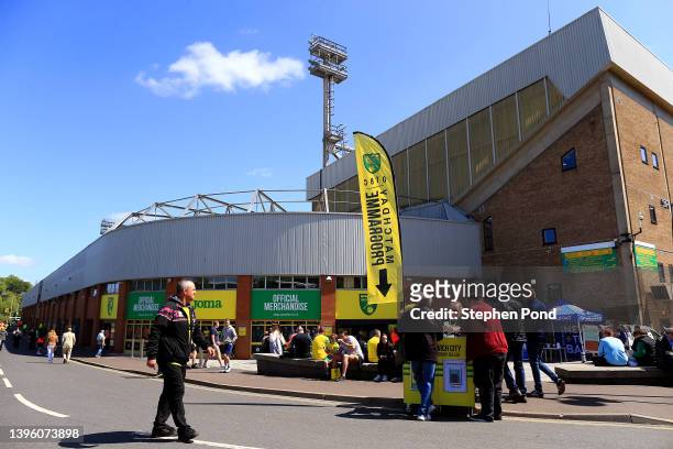 Fans arrive outside the stadium ahead of the Premier League match between Norwich City and West Ham United at Carrow Road on May 08, 2022 in Norwich,...