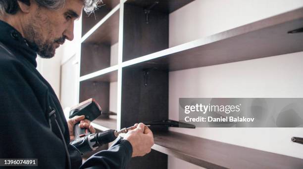 disassembly of wooden bookcase. moving out. - building shelves stock pictures, royalty-free photos & images