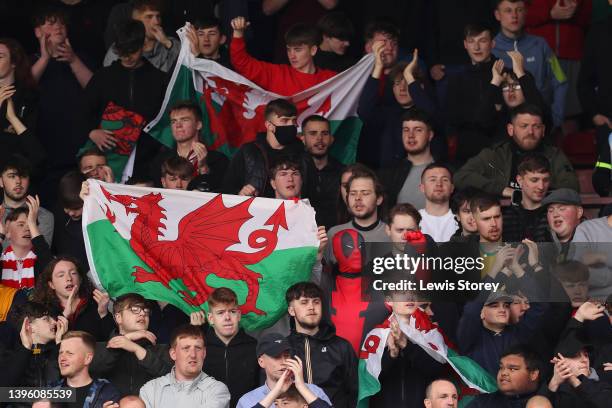 Fan of Wrexham dressed as 'Deadpool' is seen in the stands with a flag of Wales prior to the Vanarama National League match between Wrexham and...