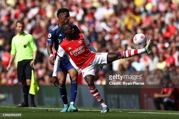 Junior Firpo of Leeds United marks Nicolas Pepe of Arsenal during the Premier League match between Arsenal and Leeds United at Emirates Stadium on...