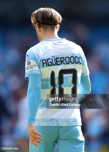 Jack Grealish of Manchester City warms up, whilst wearing a limited edition shirt to commemorate the 10 Year Anniversary of the Premier League title...