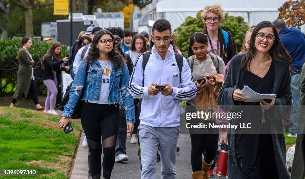 Prof. Donna Freitas, of Adelphi University in Garden City, New York, leads her class to campus security, where many of them will leave their...