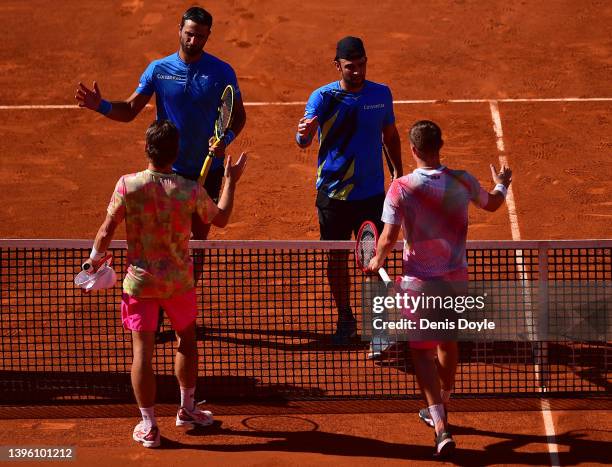 Robert Farah and Juan Sebastian Cabal of Colombia embrace Wesley Koolhof of The Netherlands and Neal Skupski of Great Britain in the men's doubles...
